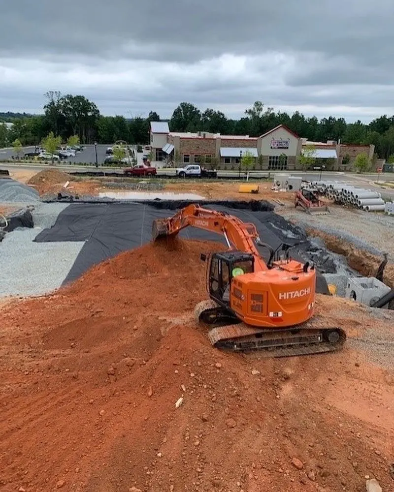 EC Grading excavator shaping a commercial site